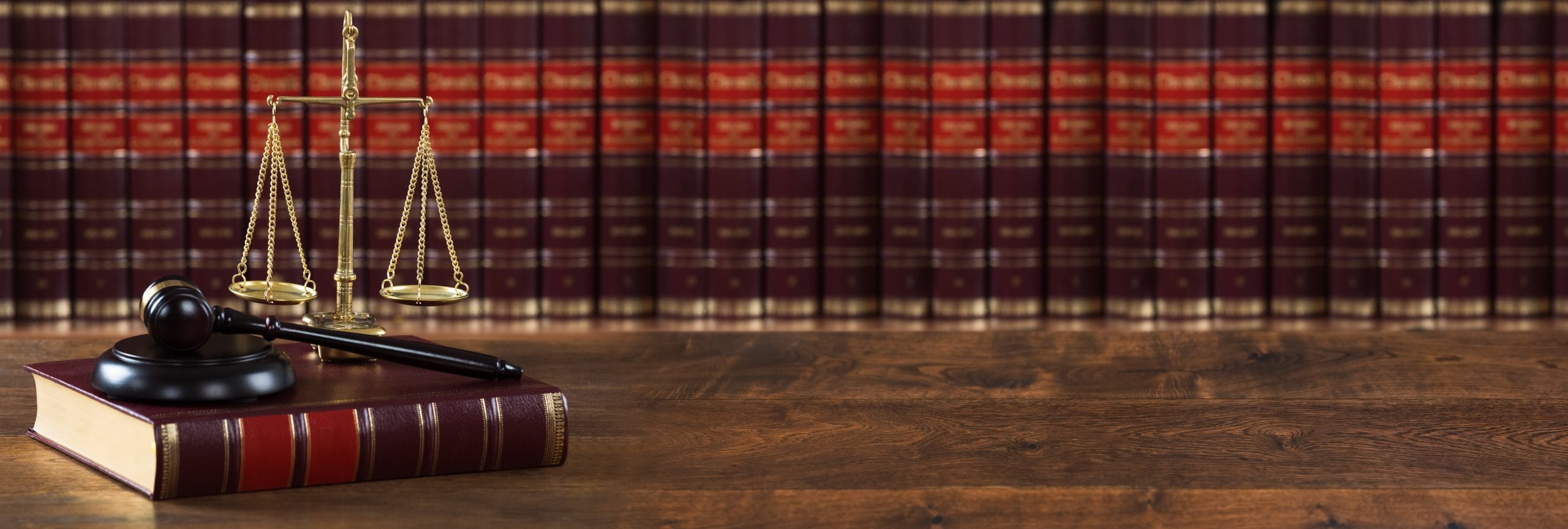 Mallet And Legal Book With Justice Scale On Table