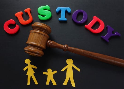 Paper family and gavel with Custody in play letters